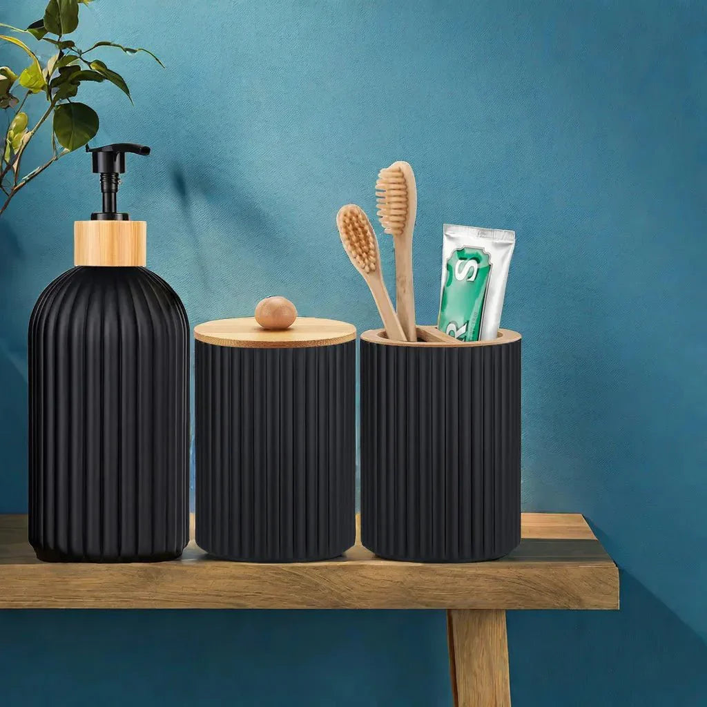 RIGO™ Bathroom Dispenser Set in matte black with ribbed texture, featuring a soap dispenser, toothbrush holder, and cotton container, accented with bamboo tops.