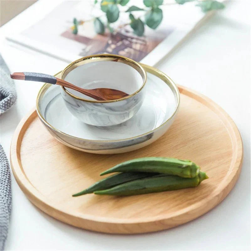 Round wooden serving tray with natural grain, holding a bowl and vegetables, perfect for daily essentials.