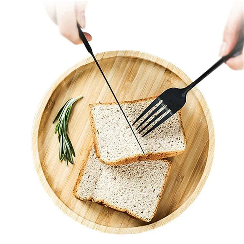 Round wooden serving tray with bread slices and utensils, highlighting natural grain and warm tone.