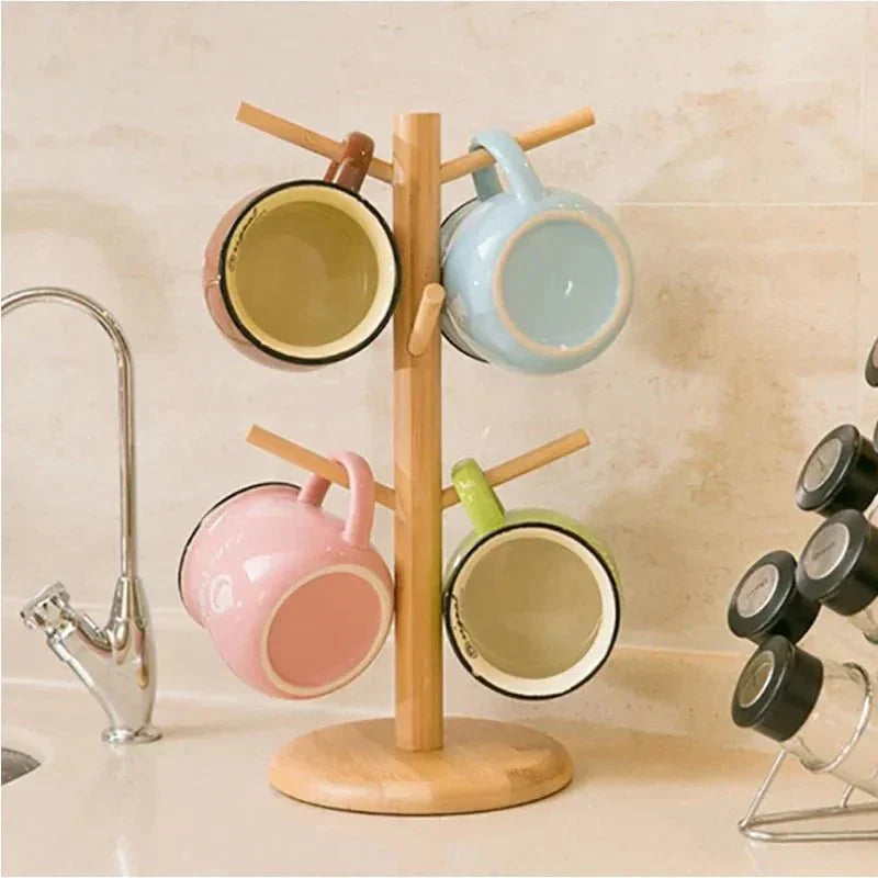 Rotating wooden cup stand with mugs, kitchen counter display.