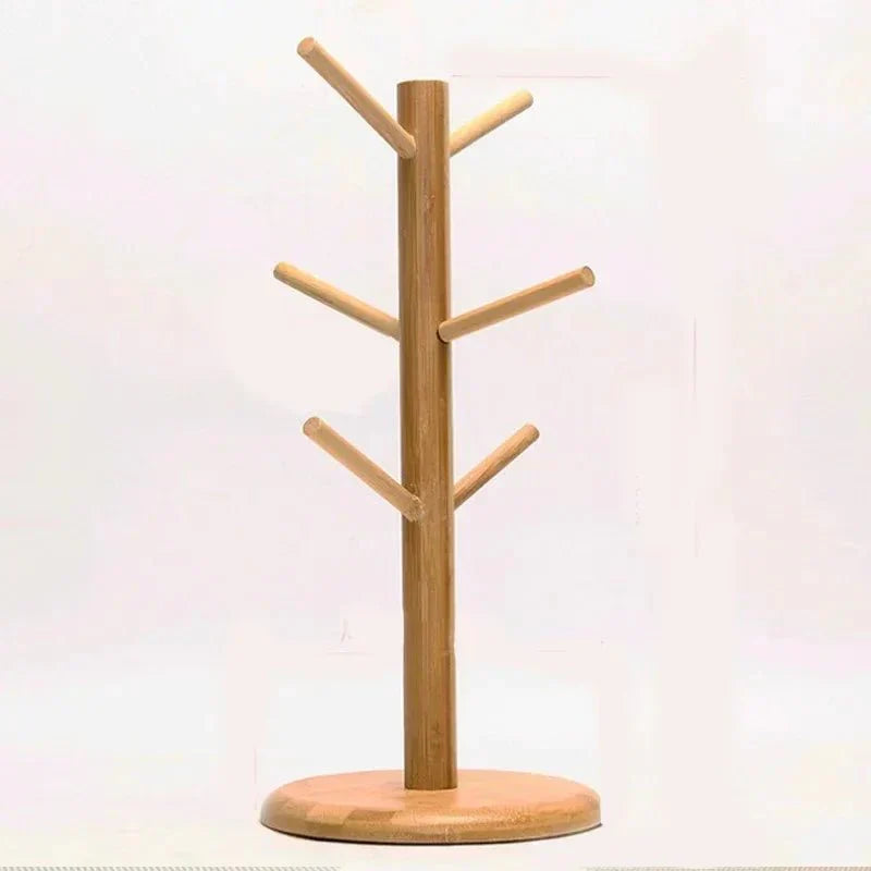 Rotating wooden cup stand with tree-like design, ideal for organizing mugs and teacups in the kitchen.