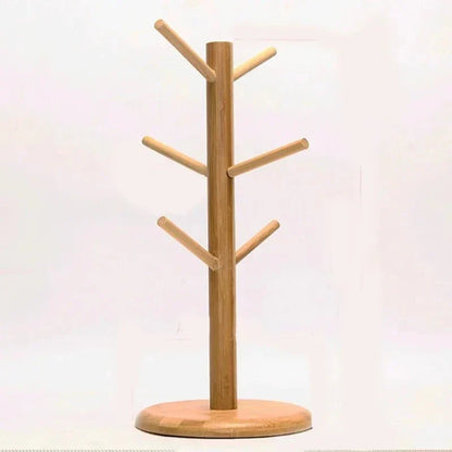 Rotating wooden cup stand with tree-like design, ideal for organizing mugs and teacups in the kitchen.